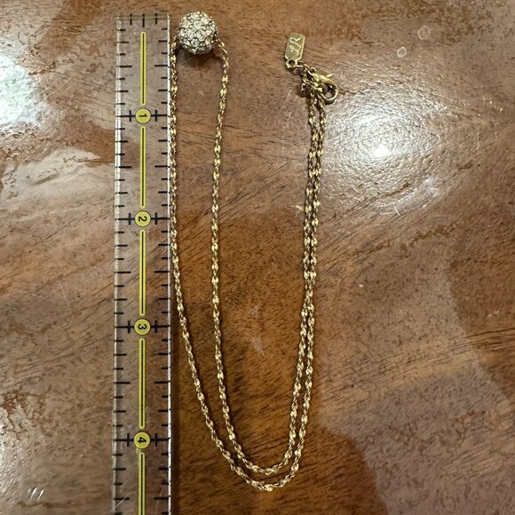 This necklace is a gold-tone with a rhinestone ball pendant. - Picture 7 of 7